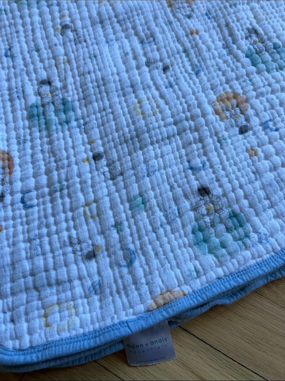 Aden + Anais Baby Muslin Blanket in White space print with Blue Trim